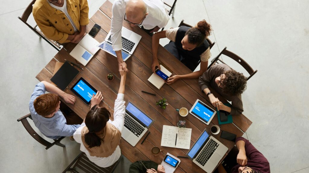 People sitting around a meeting room table.